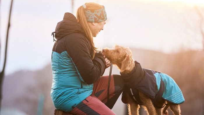 owner putting on a coat in winter