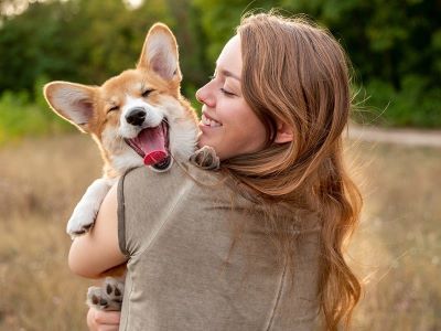 a happy dog hugging the owner