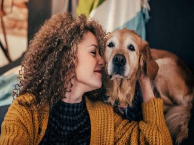 a woman kissing a dog 